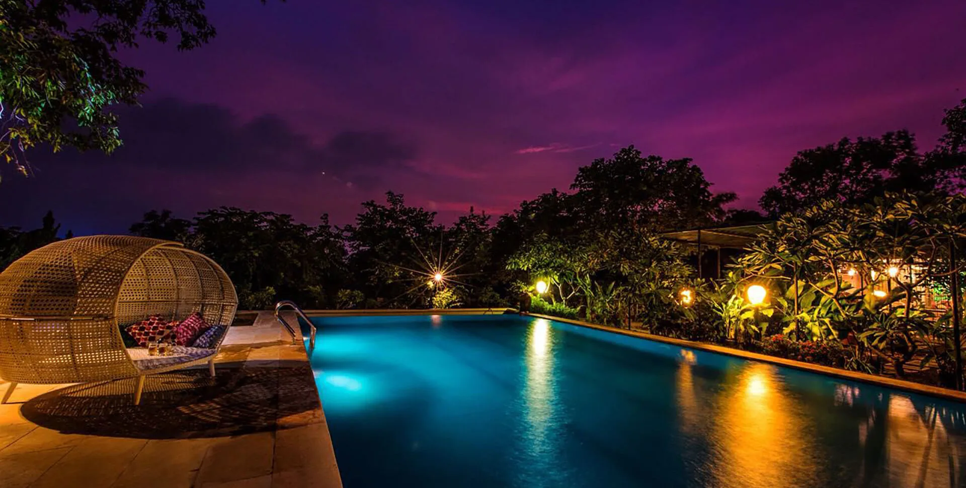 Tooth Mountain Farms property and pool in Karjat at night.